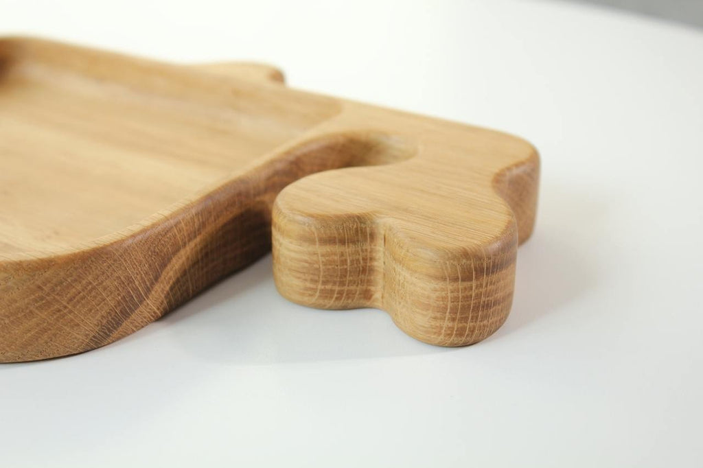 3. Close-up of the fin detail on a wooden whale-shaped plate for kids, highlighting the polished surface and wood grain.