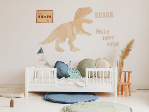 1. Playful children's bedroom featuring 'Be Roarr Kid' poster, dinosaur decor, and cozy cushions on white bed