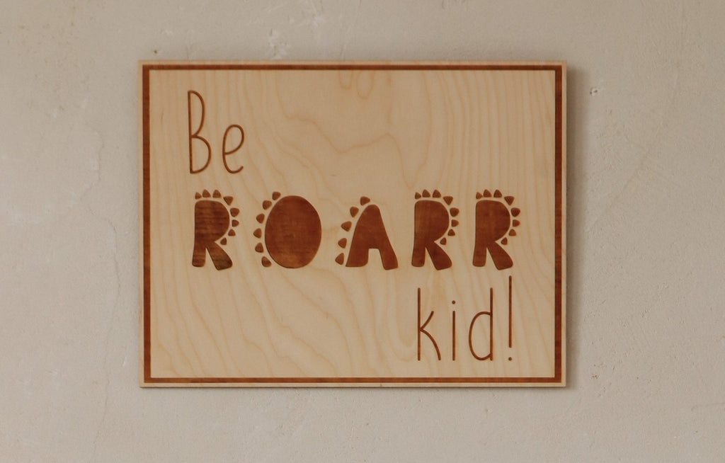 3. Close-up of engraved plywood poster with 'Be Roarr Kid' text, showcasing natural wood grain and rustic charm