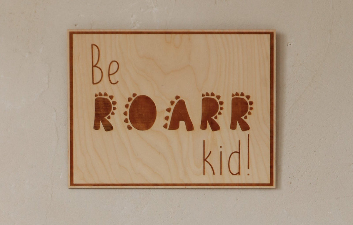 3. Close-up of engraved plywood poster with 'Be Roarr Kid' text, showcasing natural wood grain and rustic charm