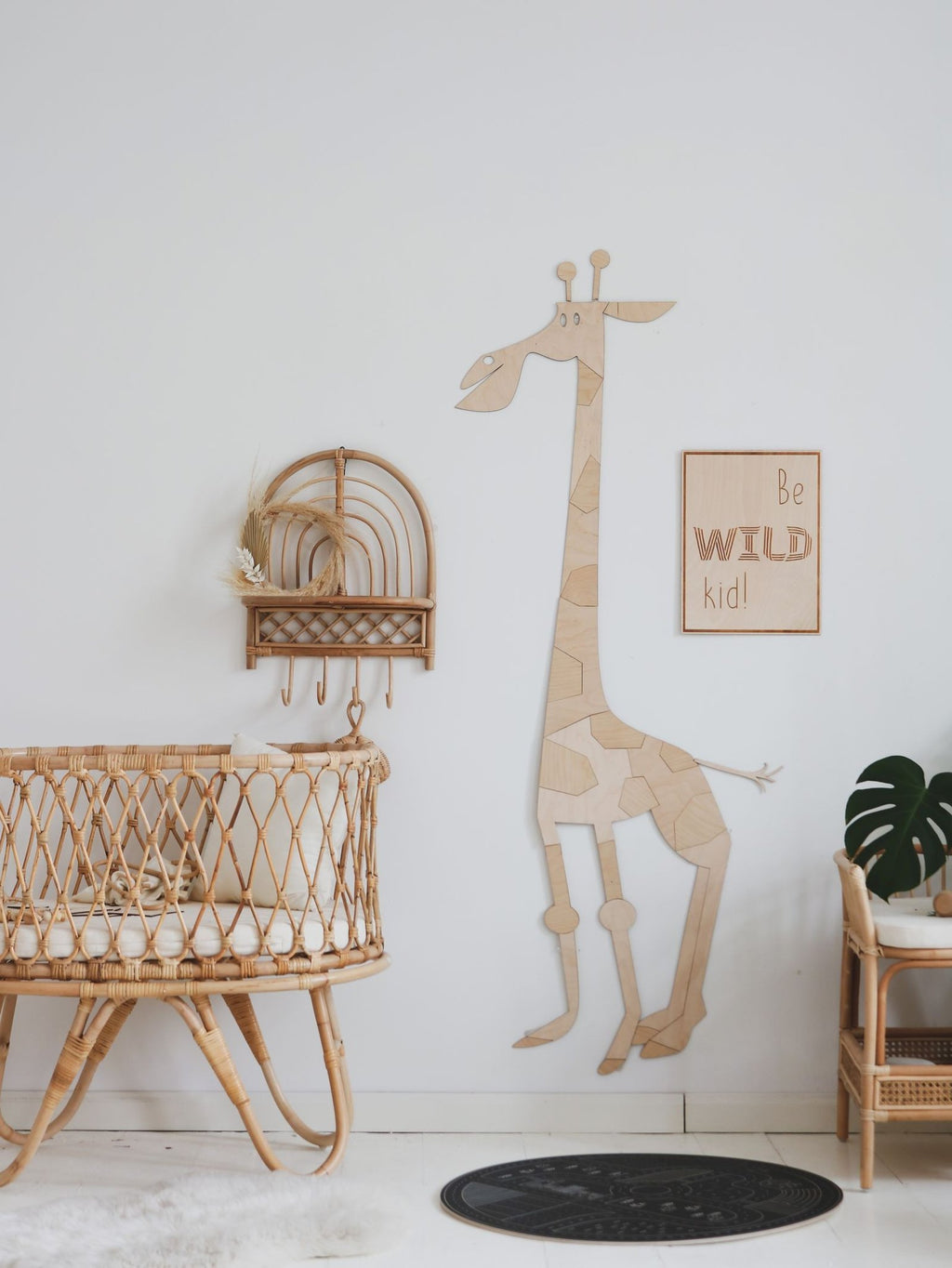 1. Children's room with wooden poster 'Be Wild Kid' on wall, featuring giraffe wall art and wicker furniture
