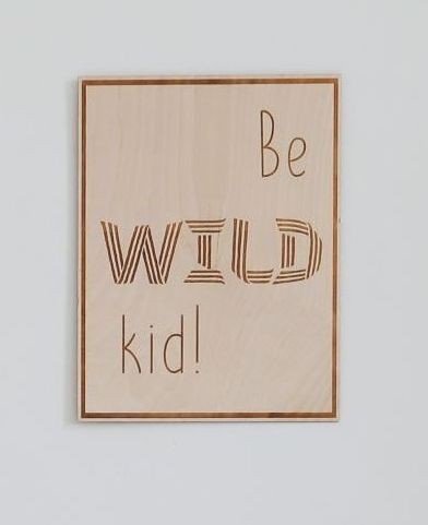 3. Close-up of engraved wooden poster with 'Be Wild Kid' text on plywood