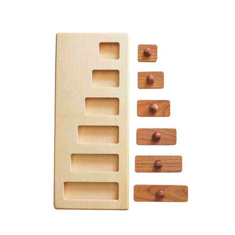 1. Flat lay of Wooden Story wooden puzzle blocks with different lengths and knobs, shown next to a wooden base with corresponding slots on a white background