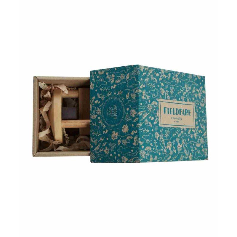 4. Fieldfare wooden rattle partially inside open blue decorative box, highlighting eco-friendly packaging