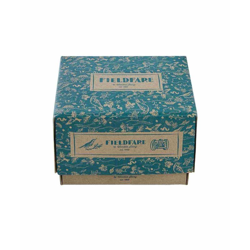 4. Flat lay of Fieldfare wooden rattle packaging with decorative blue design and brand logo