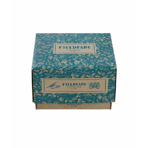 4. Flat lay of Fieldfare wooden rattle packaging with decorative blue design and brand logo