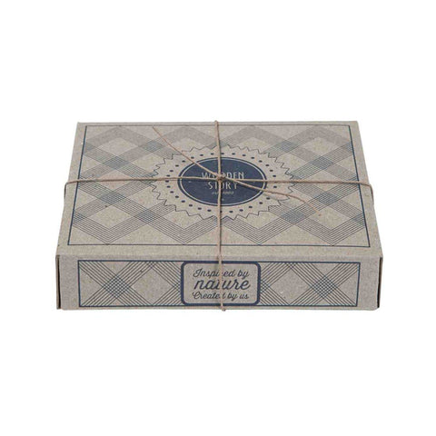 2. Eco-friendly packaging for Wooden Story rattle, featuring a decorative box with twine, showcasing brand logo and nature-inspired design