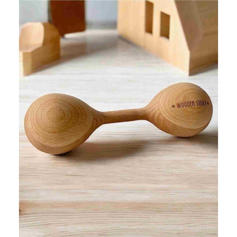 1. Wooden Story Lark wooden rattle on wooden surface with toy blocks in background