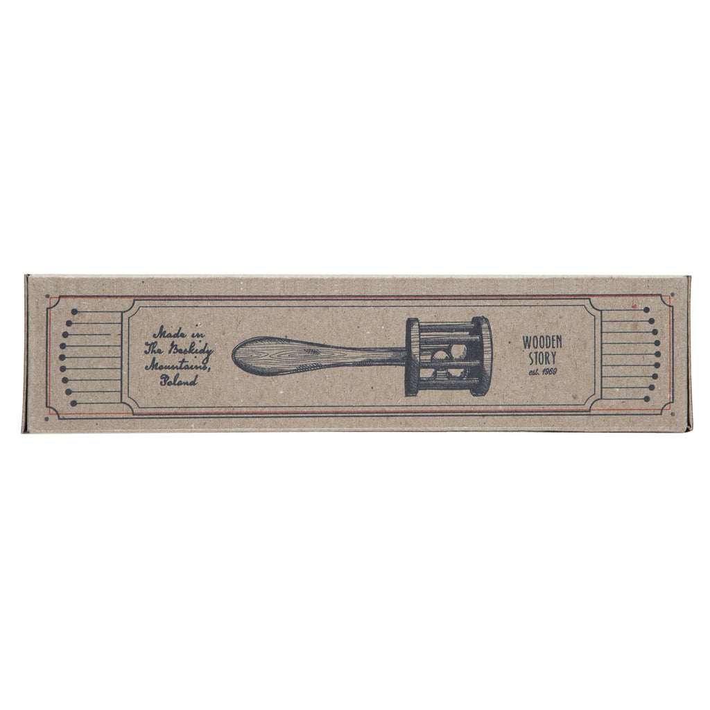 9. Long side view of Wooden Story packaging with rattle illustration and brand details