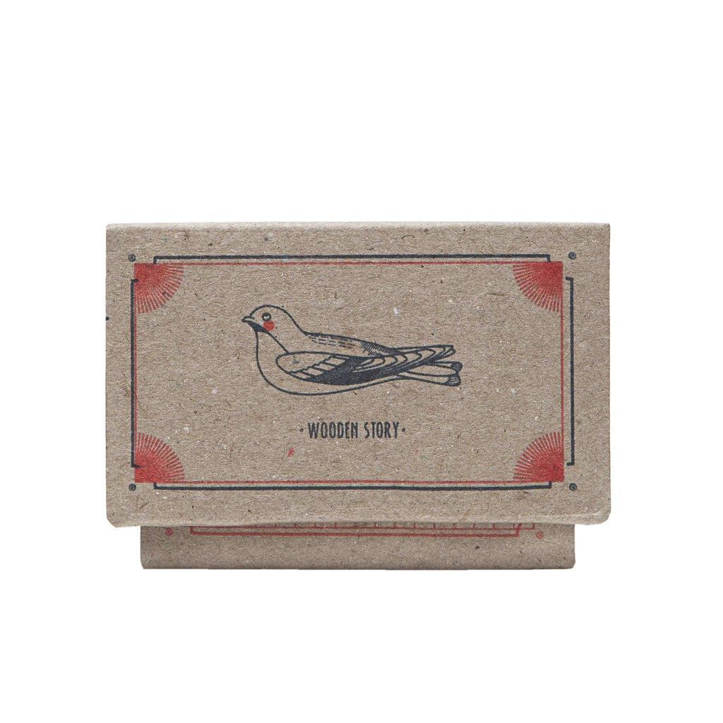 8. Close-up of Wooden Story packaging with bird illustration and brand name
