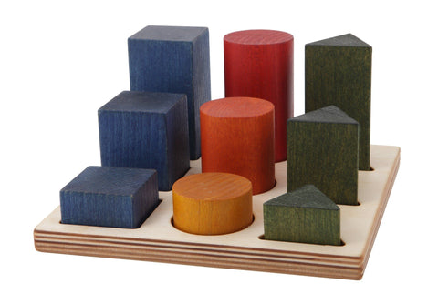 2. Wooden shape sorting blocks in various colors and shapes on a wooden board, studio setting