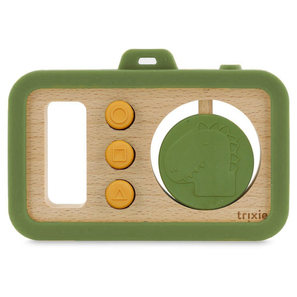 2. Studio shot of Trixie Baby's wooden silicone baby camera with green frame, yellow buttons, and dinosaur disc on white background
