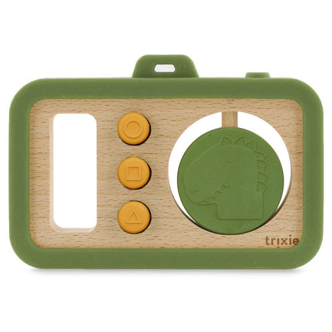 2. Studio shot of Trixie Baby's wooden silicone baby camera with green frame, yellow buttons, and dinosaur disc on white background