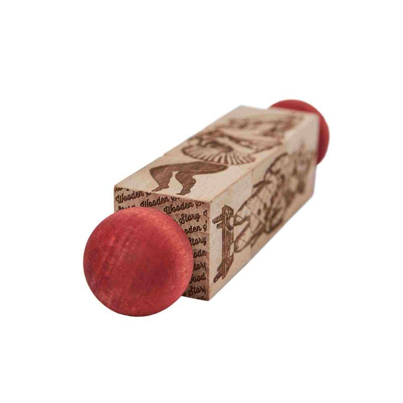 3. Angled view of Commedia Dell'Arte wooden spinning puzzle showing engraved details and red ends