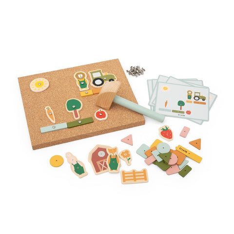 3. Studio shot of Trixie Baby wooden tap tap game set with cork board, hammer, farmyard pieces, and playing cards