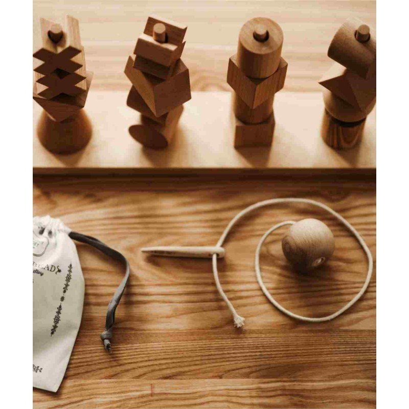 4. Flat lay of Wooden Story threading needle with wooden blocks and cotton bag on wooden surface