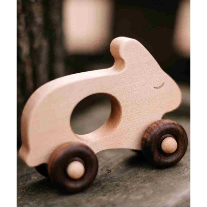 1. Wooden rabbit toy on wheels placed on wooden surface with blurred background