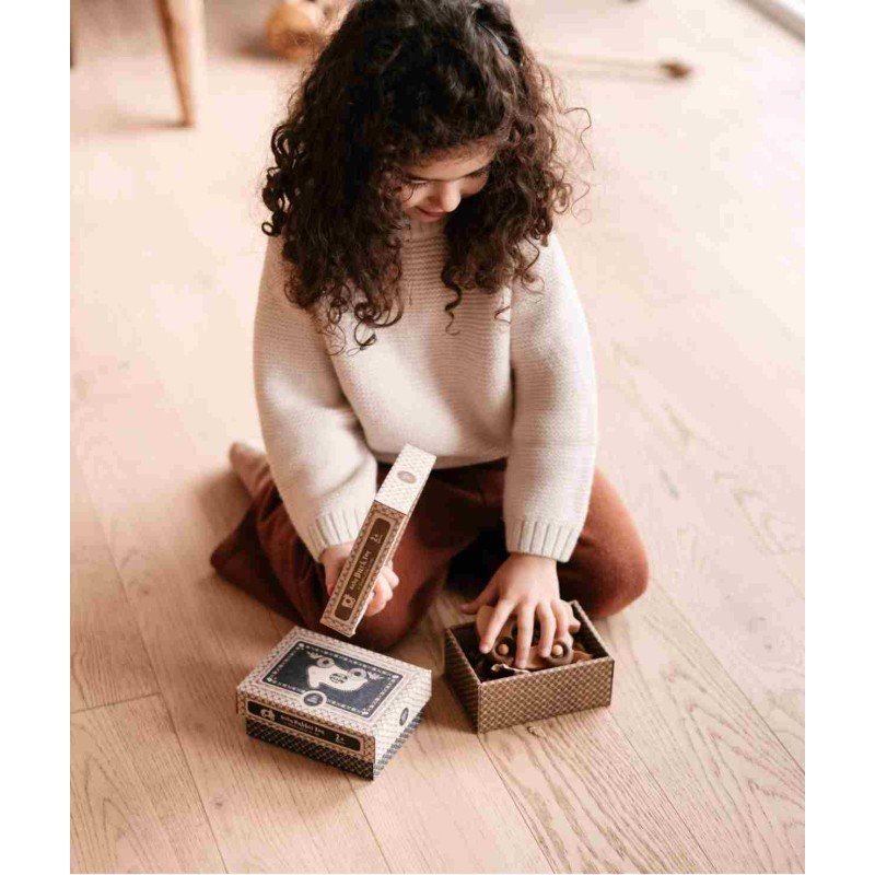 1. Child holding wooden rabbit toy on wheels, focusing on toy's smooth finish and design