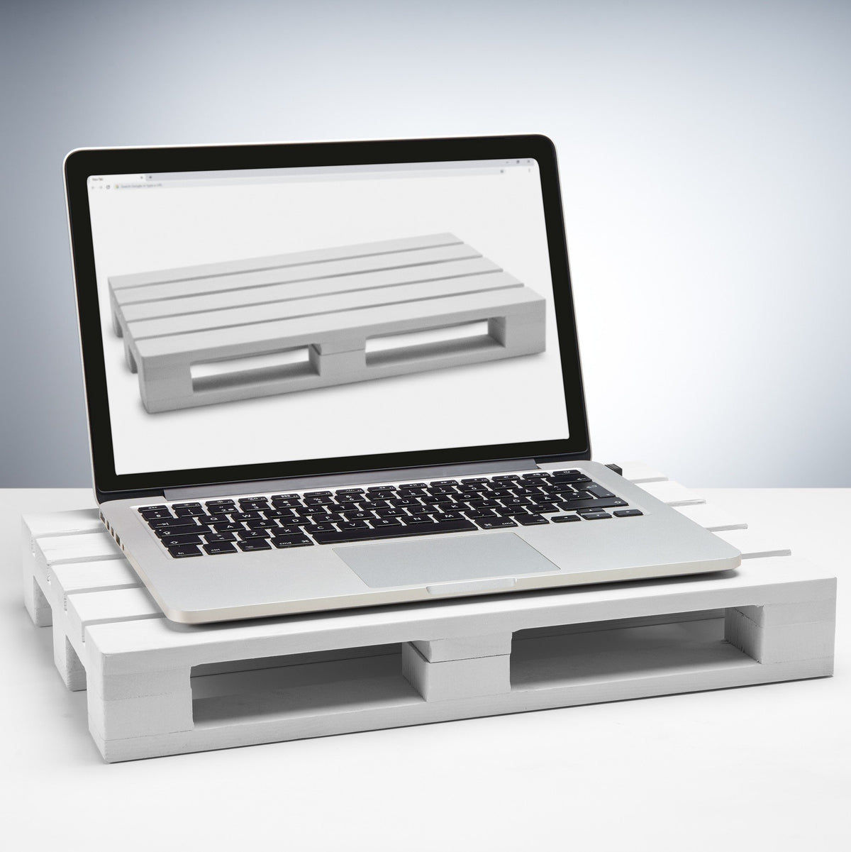 1. Laptop on a white wooden tray used as a stand on a white surface