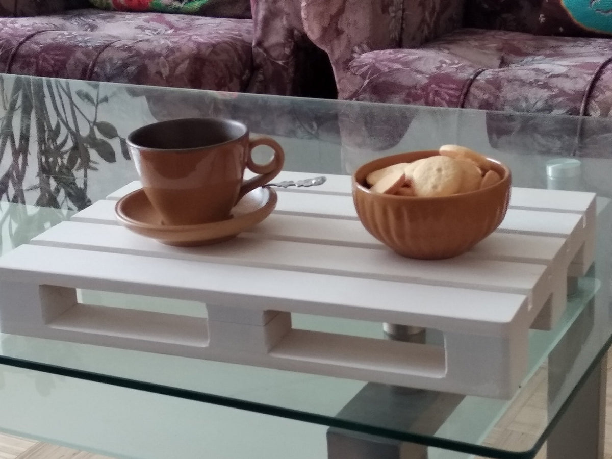 1. Brown cup and bowl on a white wooden tray on a glass table