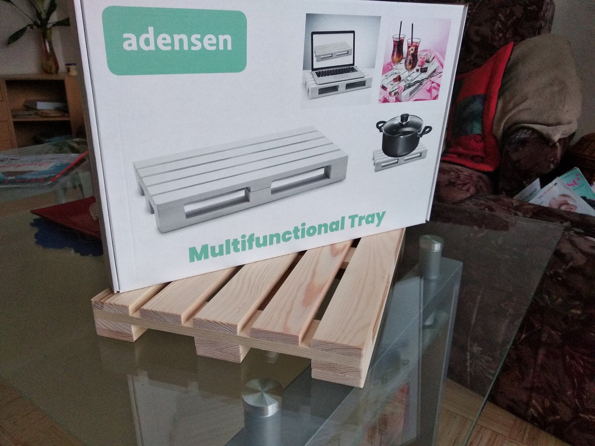 4. Flat lay of natural wooden tray with Adensen packaging on a glass table