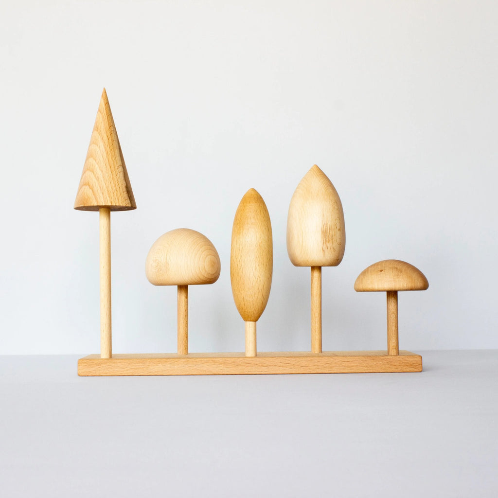 8. Wooden Story tree crown puzzle with five wooden tree shapes on a base, displayed in a studio setting