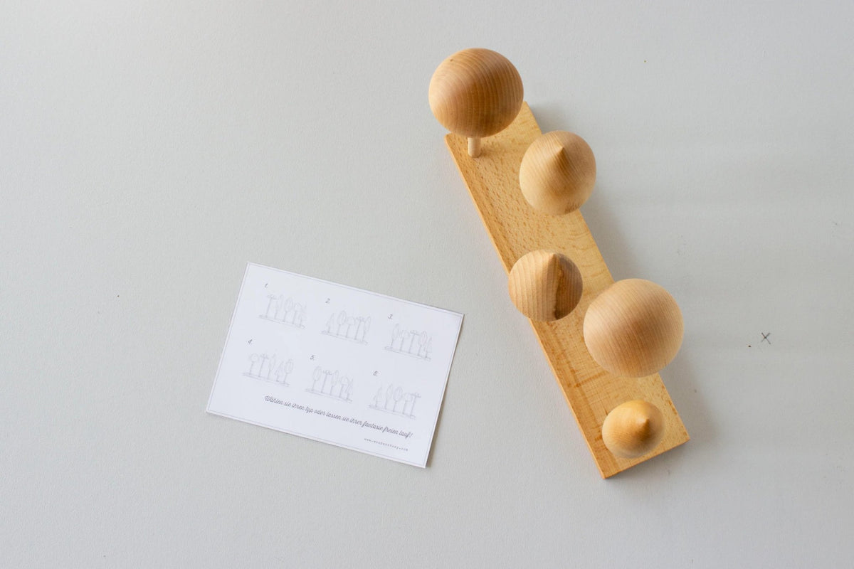 7. Top view of Wooden Story tree crown puzzle with round wooden shapes on a base and instruction card