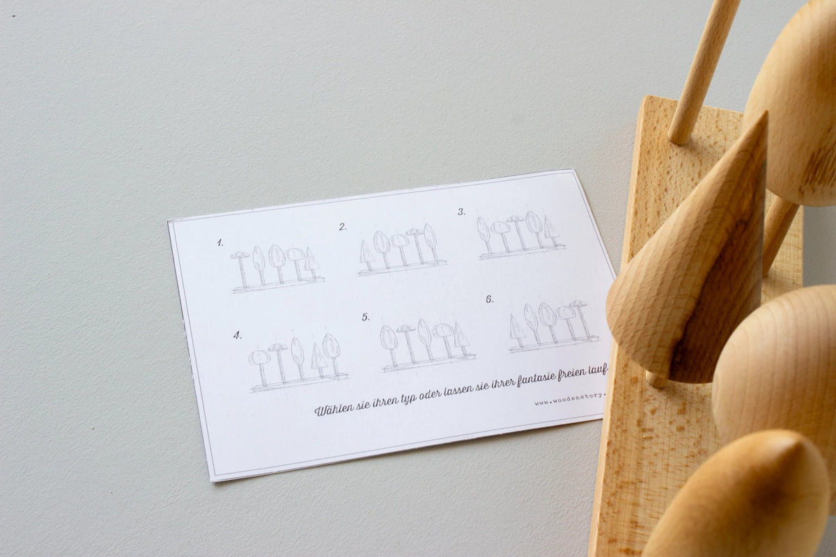 6. Instruction card for Wooden Story tree crown puzzle with partial view of wooden tree shapes on a base