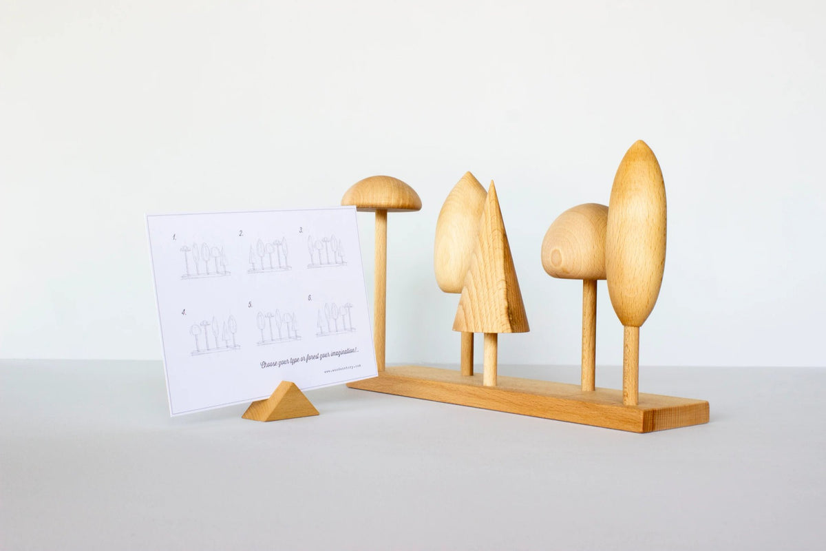 5. Wooden Story tree crown puzzle with instruction card, featuring five wooden tree shapes on a base in a studio setting