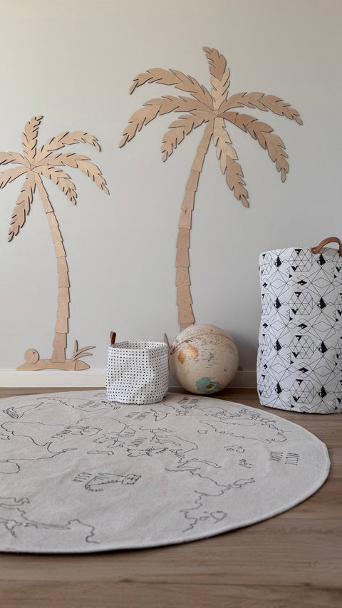 5. Children's room with two wooden palm tree wall decors, natural plywood, featuring a round play mat and storage baskets