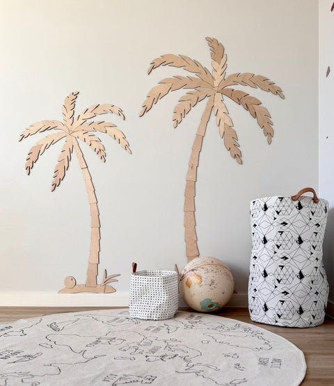 2. Minimalist children's room featuring two wooden palm tree wall decors made from natural plywood, with a globe and storage baskets on the floor