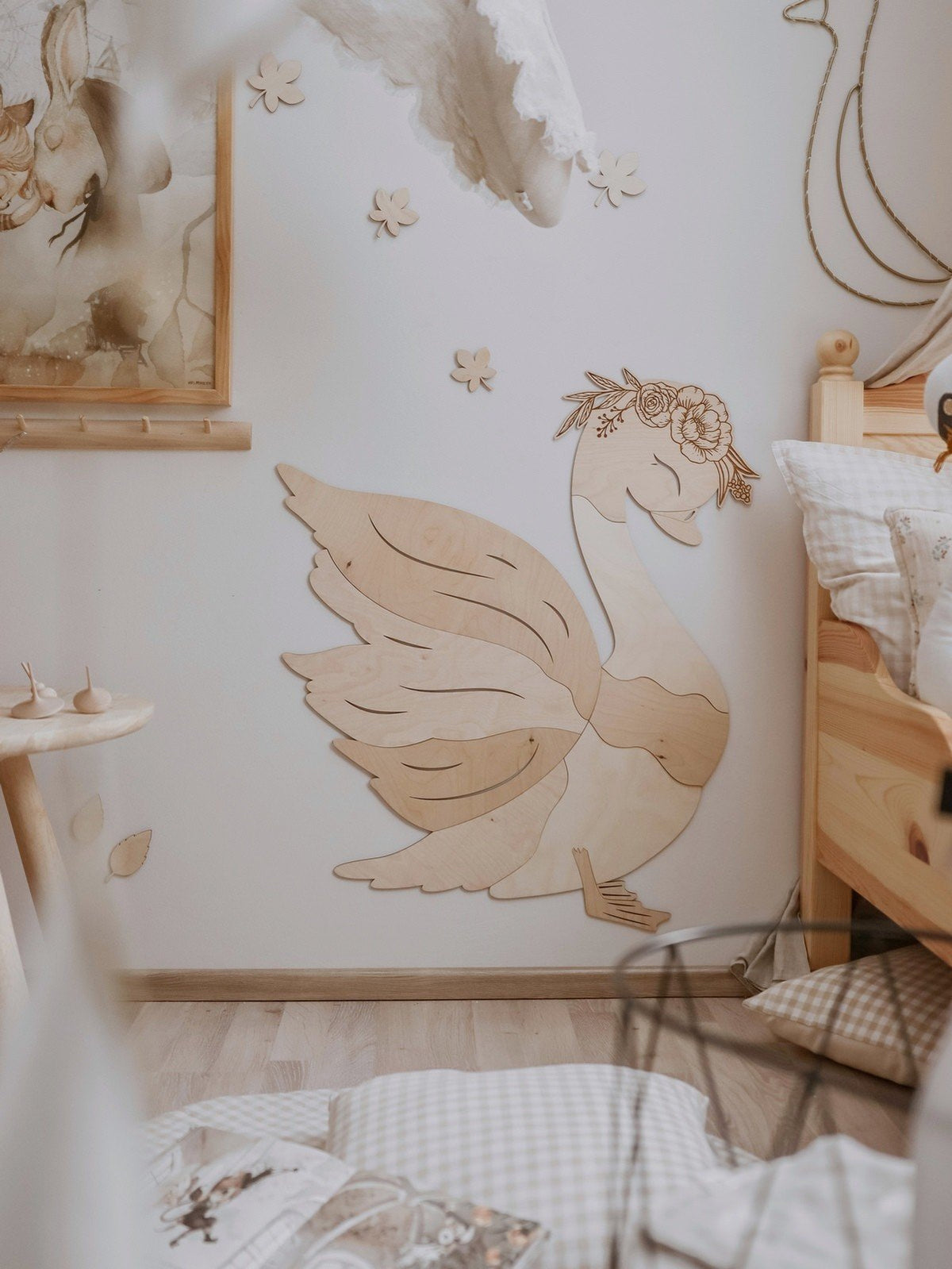 1. Wooden swan wall decoration in a child's room with natural wood furniture and soft decor accents