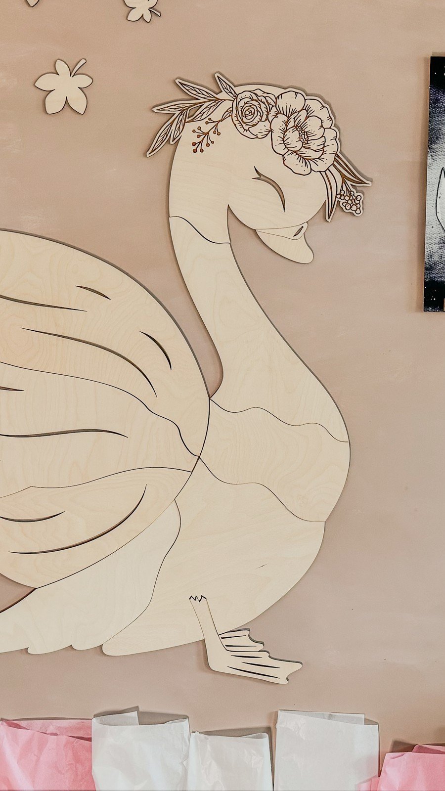 2. Wooden swan wall decoration on a beige background showing puzzle-like assembly