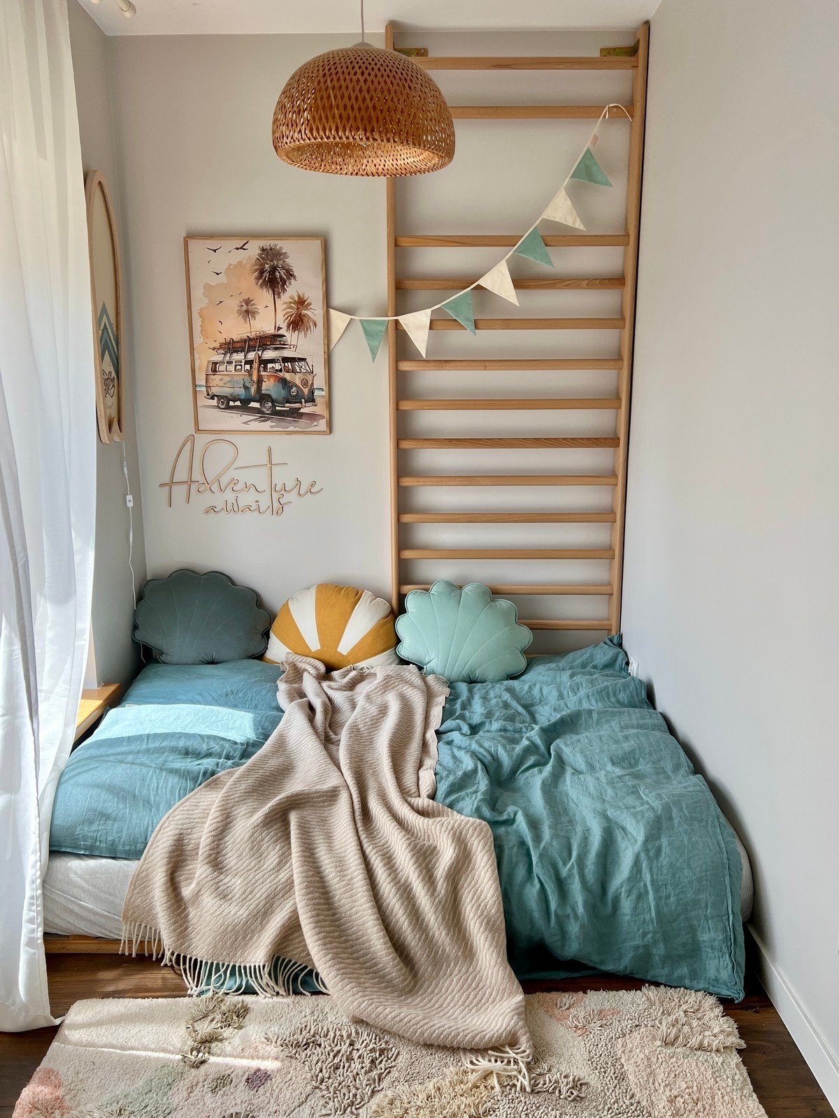 7. Cozy child's room with 'Adventure Awaits' wooden sign, colorful pillows, and decorative bunting