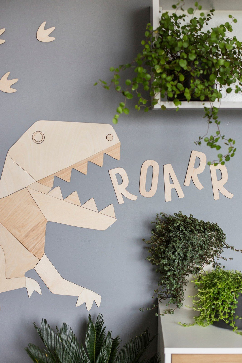 5. Wooden dinosaur and 'ROARR' wall sign on grey wall with green plants, made from 4mm plywood