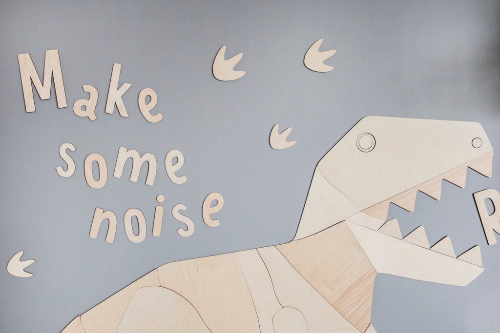 6. Wooden dinosaur and 'Make some noise' wall sign on grey wall with dinosaur footprints, made from 4mm plywood
