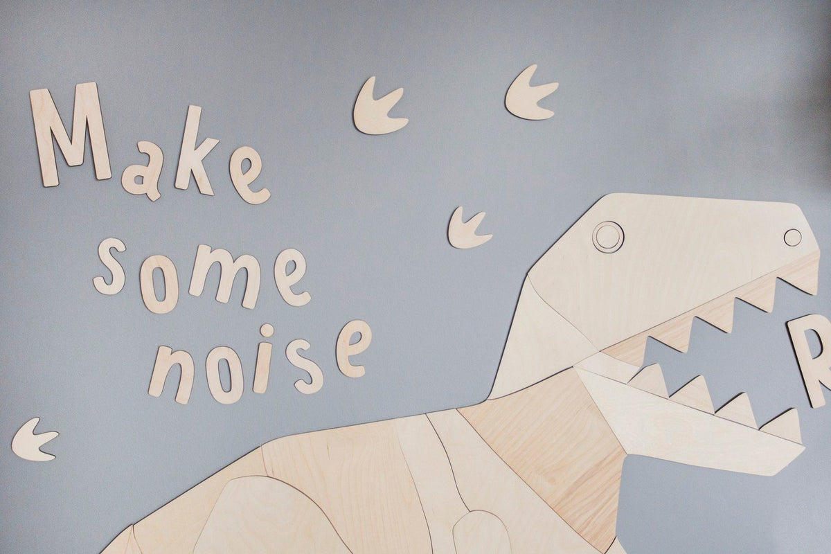 6. Wooden dinosaur and 'Make some noise' wall sign on grey wall with dinosaur footprints, made from 4mm plywood