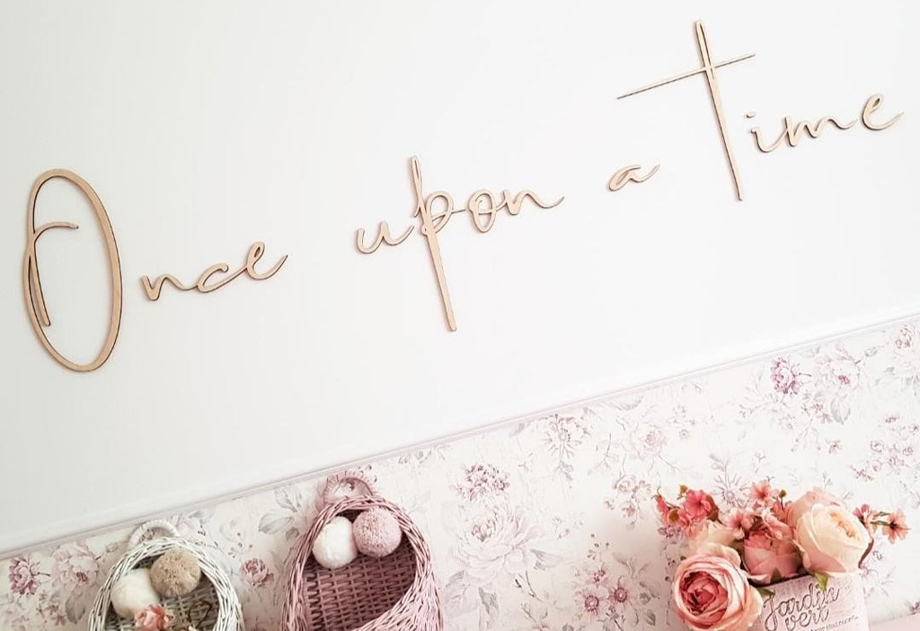 3. Close-up of 'Once upon a time' wooden wall sign on a floral wallpaper background, adding a magical touch to a child's room decor