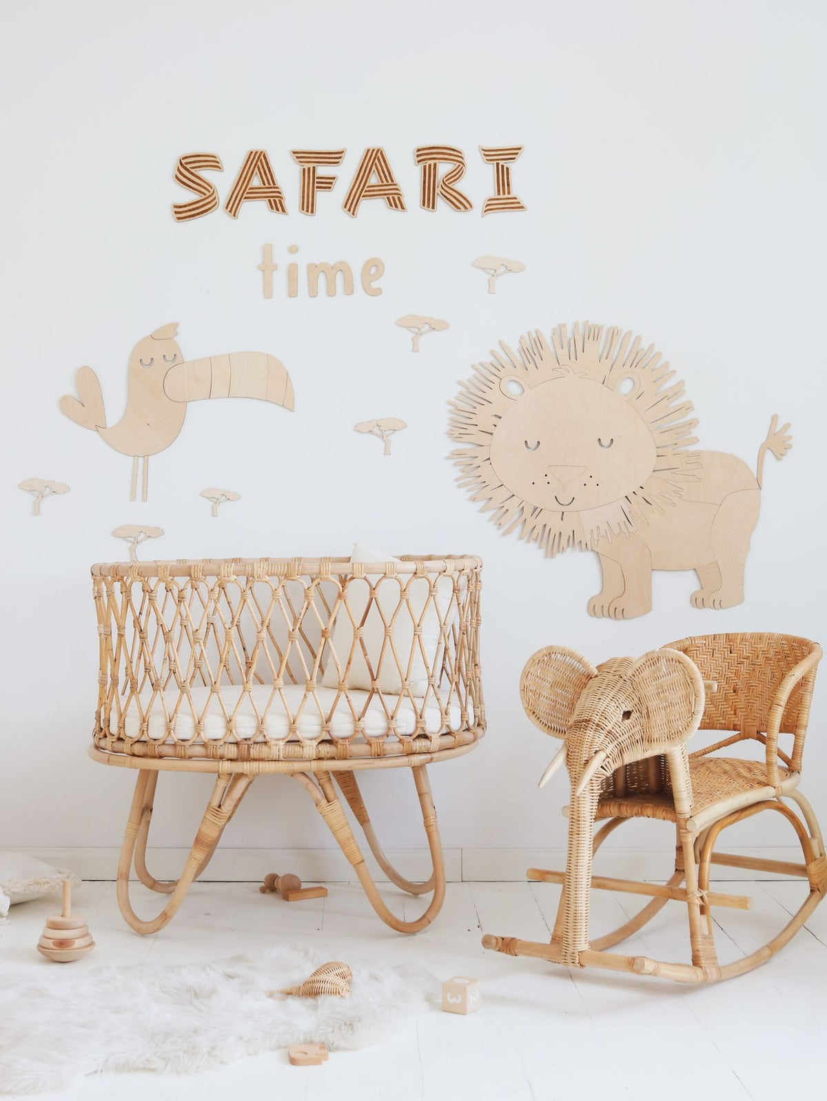 5. Nursery with 'Safari Time' wooden wall sign, wicker crib, and lion and bird decorations