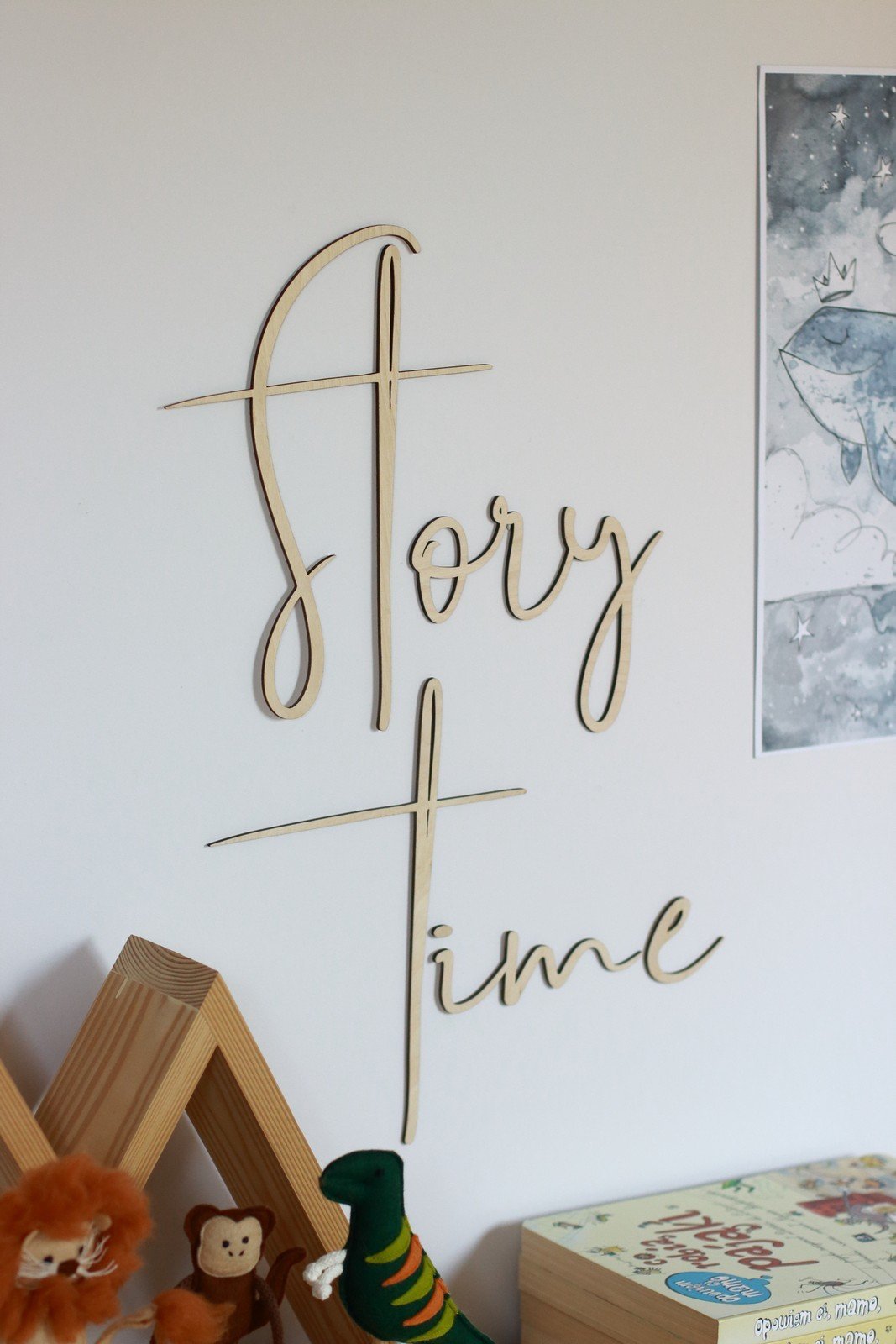 3. Side view of 'Story Time' wooden wall sign in a child's room, accompanied by toy animals and a whimsical whale illustration.
