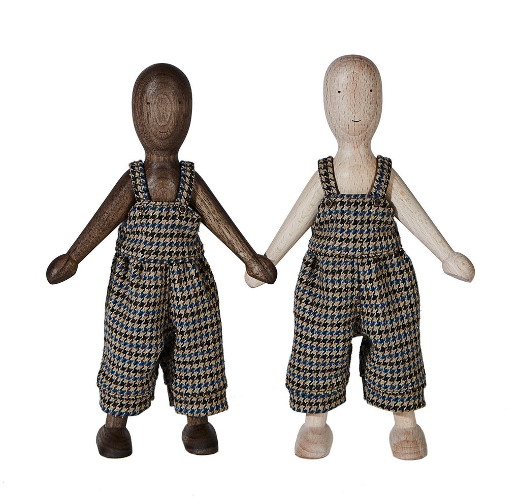 1. Two wooden dolls in walnut and beech finish wearing houndstooth pants, standing side by side on a white background