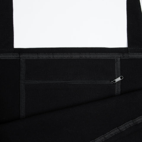 4. Close-up of black XXL Novels Tote Bag interior, showing zipper pocket and heavy cotton material