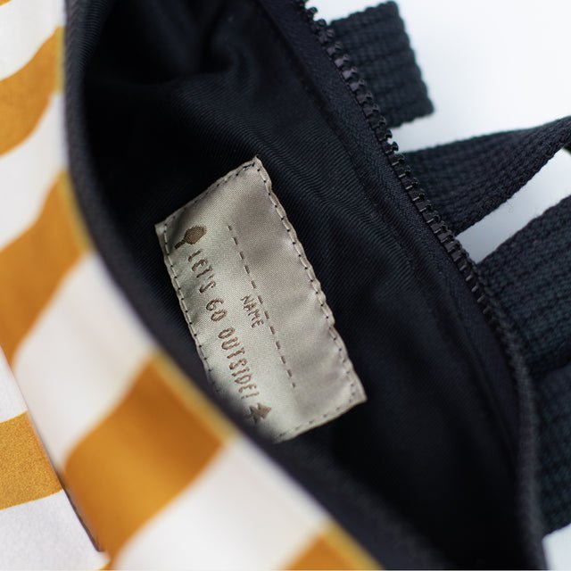 9. Close-up of interior label on Muni striped mustard and white backpack