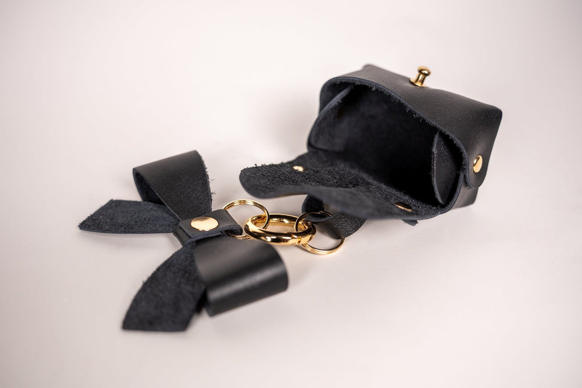 10. Open Zelma Kraft mini leather charm with bow, showing interior and gold hook