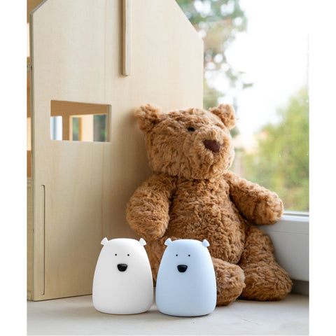 3. White and arctic blue mini bear lights by Rabbit & Friends beside a teddy bear near a wooden dollhouse