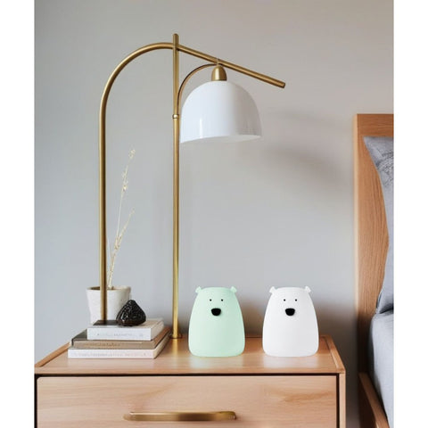 1. White and arctic green mini bear lights on a wooden bedside table with a modern lamp